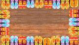 Brightly colored flip-flops on wood 