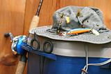 Closeup of fishing tackle box and hat
