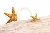 Crystal ball with starfish in the sand
