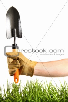 Hand holding garden trowel 