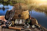 Traditional fly-fishing rod with equipment in late afternoon