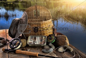 Traditional fly-fishing rod with equipment in late afternoon
