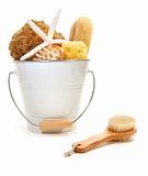 White bucket filled with sponges and scrub brushes 
