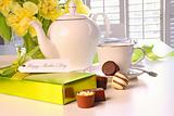 Box of chocolates on table with tea set 