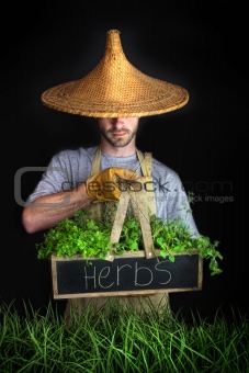 Man with Asian hat gardening 