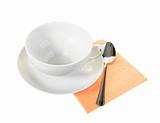 White empty mug and spoon on orange paper napkin