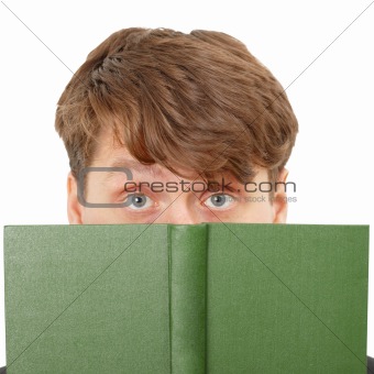 Young man hid his face behind a green book