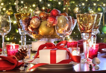  Holiday table setting with red ribboned gift