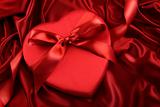 Box of chocolate on red satin 