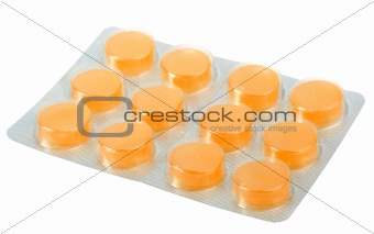 Orange pills in metallic blister