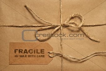 Brown shipping parcel tied with twine and tag for copy space