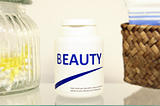 Beauty pills in a bottle on bathroom shelf