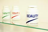 Sanity, Beauty and Youth pills in a bottle on bathroom shelf