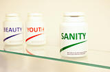 Sanity, Beauty and Youth pills in a bottle on bathroom shelf