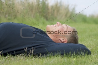Young man lying in the grass