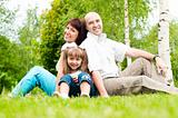 family of three on grass