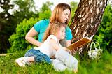 mother reading book to her daughter