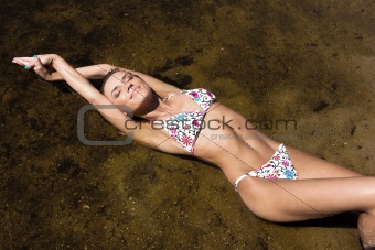 Beautiful young woman relaxing on the beach