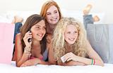 Happy teen girls after shopping clothes talking on phone