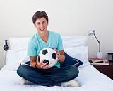 Teen guy holding a soccer ball