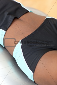 Close-up of a woman working out with a pilates ball 