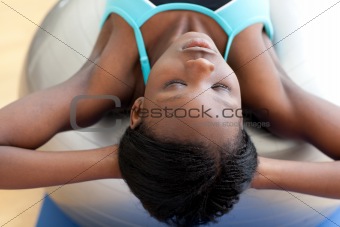 Concentrated woman working out with gym ball
