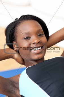 Smiling woman in gym clothes exercising
