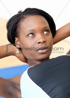 Concentrated woman in gym clothes excercising 