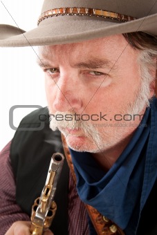 Cowboy blowing on the end of a hot pistol