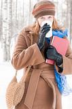 young woman with books in winter