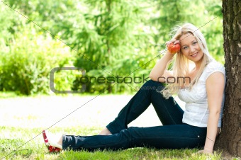 woman under the tree with apple