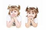 Adorable little twin girls isolated on white background 