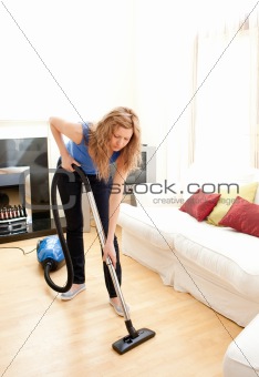 Disintersest woman cleaning her living room
