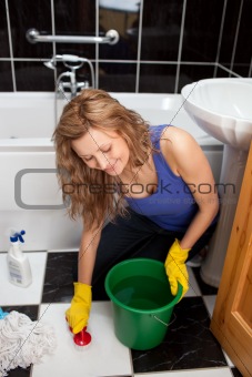 Yound woman sitting on the ground in a bathroom
