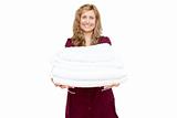 Smiling woman holding white towels