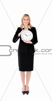 Delighted businesswoman holding a clock
