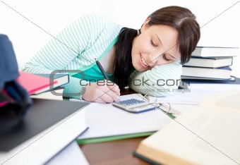 Cute woman studying sitting at a table in the living-room