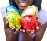 Close-up of a woman showing colorful Easter eggs