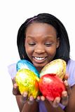Cheerful woman holding colorful Easter eggs 