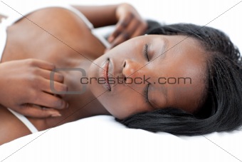 Charming woman sleeping lying on her bed 