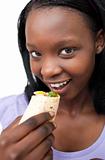 Smiling young woman eating a wrap 