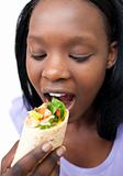 Afro-american woman eating a wrap 