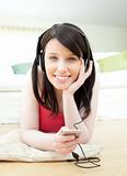 Happy woman listening music with headphones on