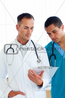 Two attractive doctors talking about a patient