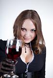 Sensual blue-eyed woman with glass of wine  