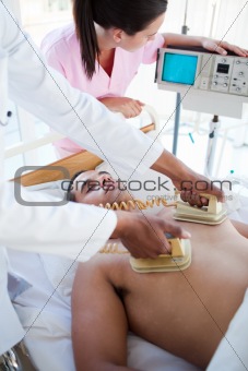 A doctor resuscitating a patient with a defibrillator