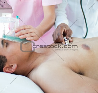 Patient receiving oxygen mask in an emergency unit