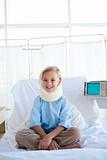 Smiling girl sitting on a hospital bed 