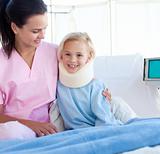 Smiling patient with a neck brace and her nurse 