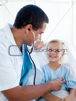 Attractive doctor checking the pulse on a young patient